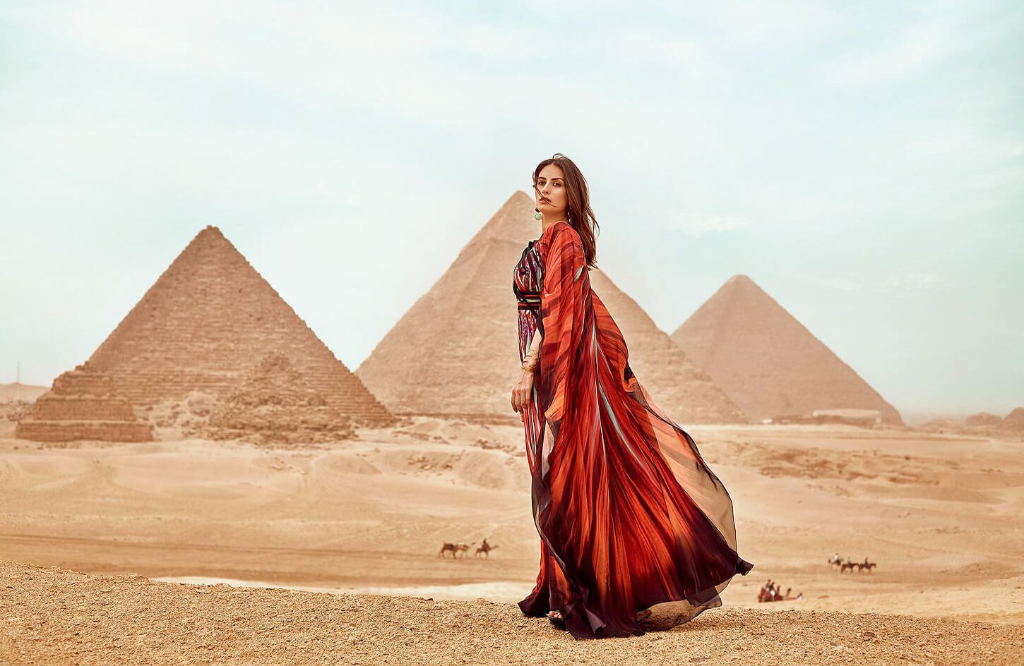 A-wonderful-picture-of-a-girl-wearing-a-red-dress-standing-in-front-of-the-pyramids